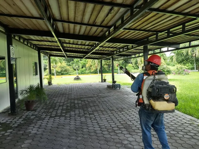 Técnico aplicando tratamiento perimetral en un jardín
